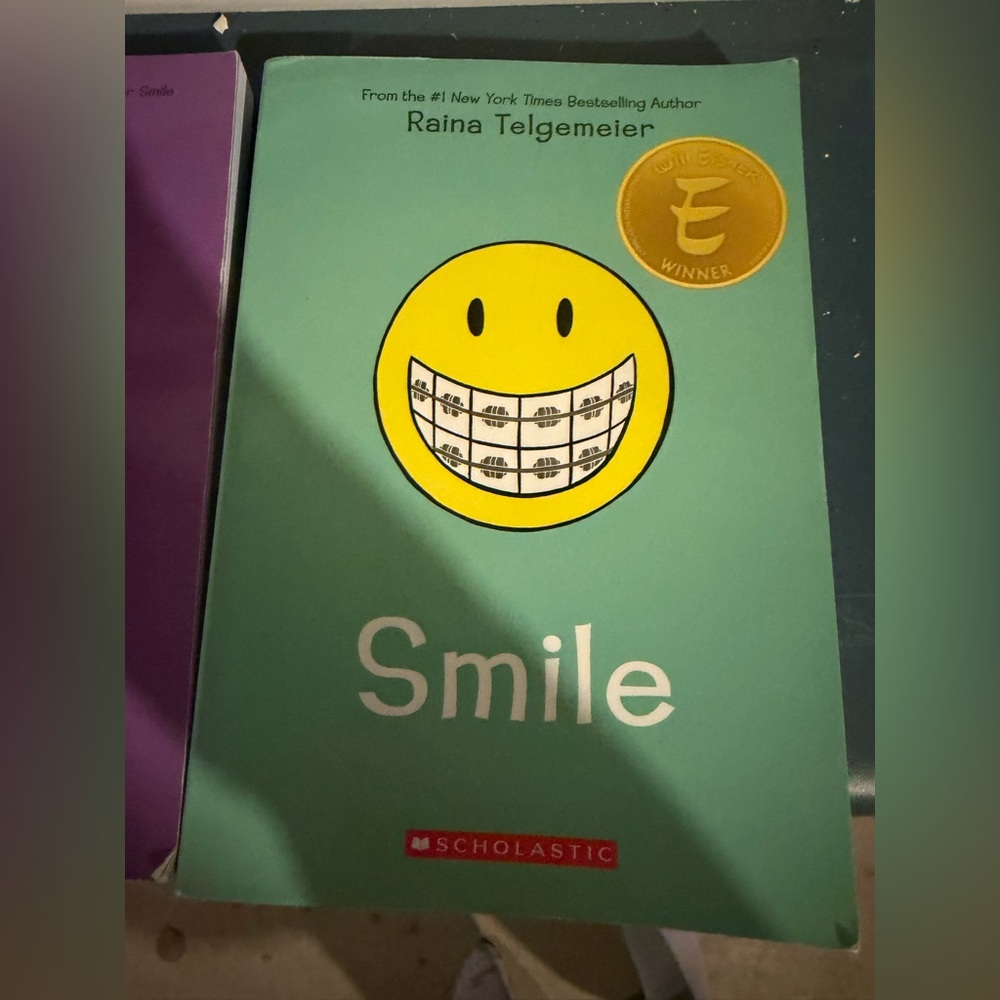 Scholastic Purple Book with Yellow Face Illustration